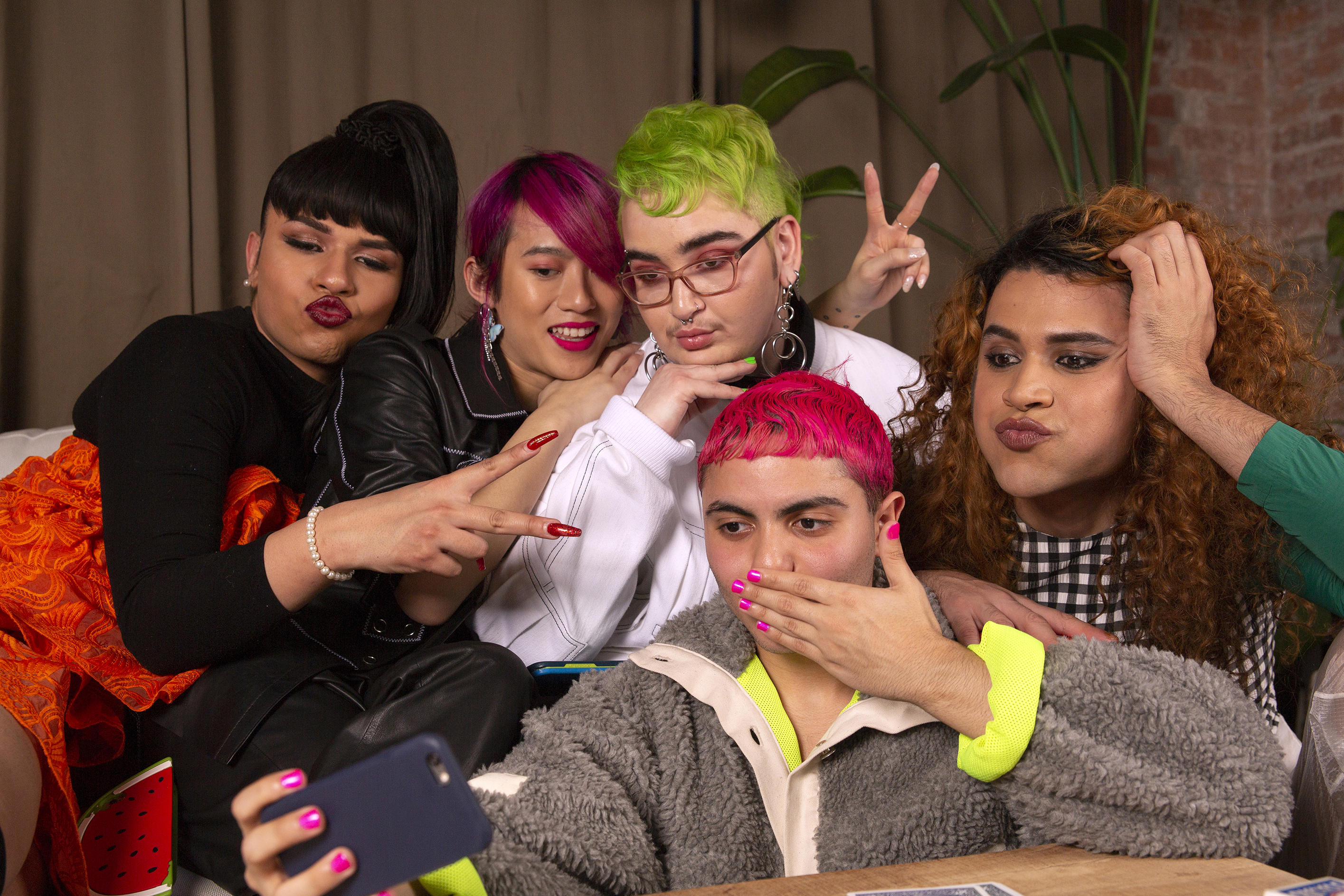 A group of friends of varying genders taking group selfie