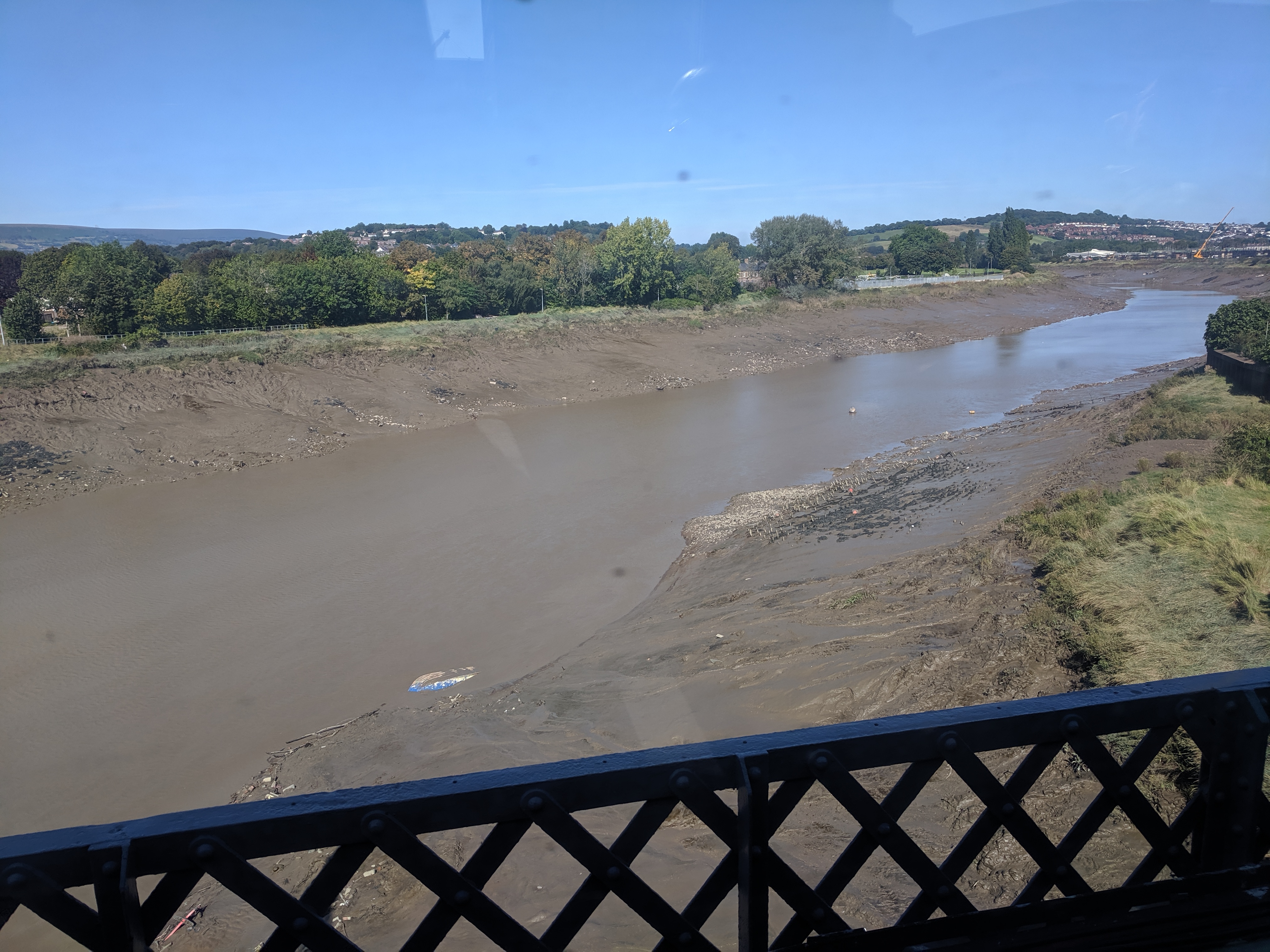 View out of a train window looking over a very muddy Severn River
